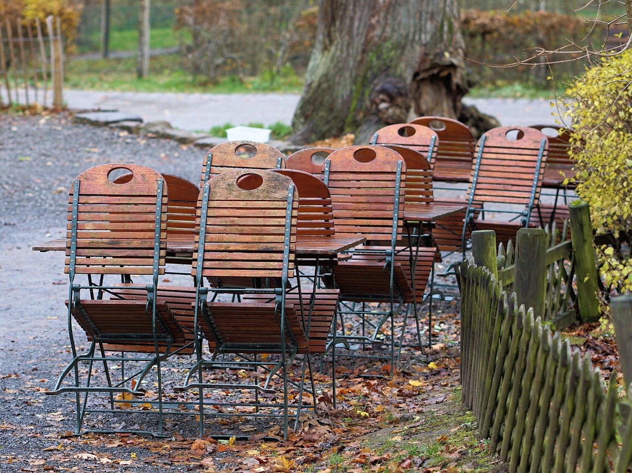 Holztische und Stühle in einem ruhigen Biergarten